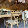Natural wood cross-back stacking chairs