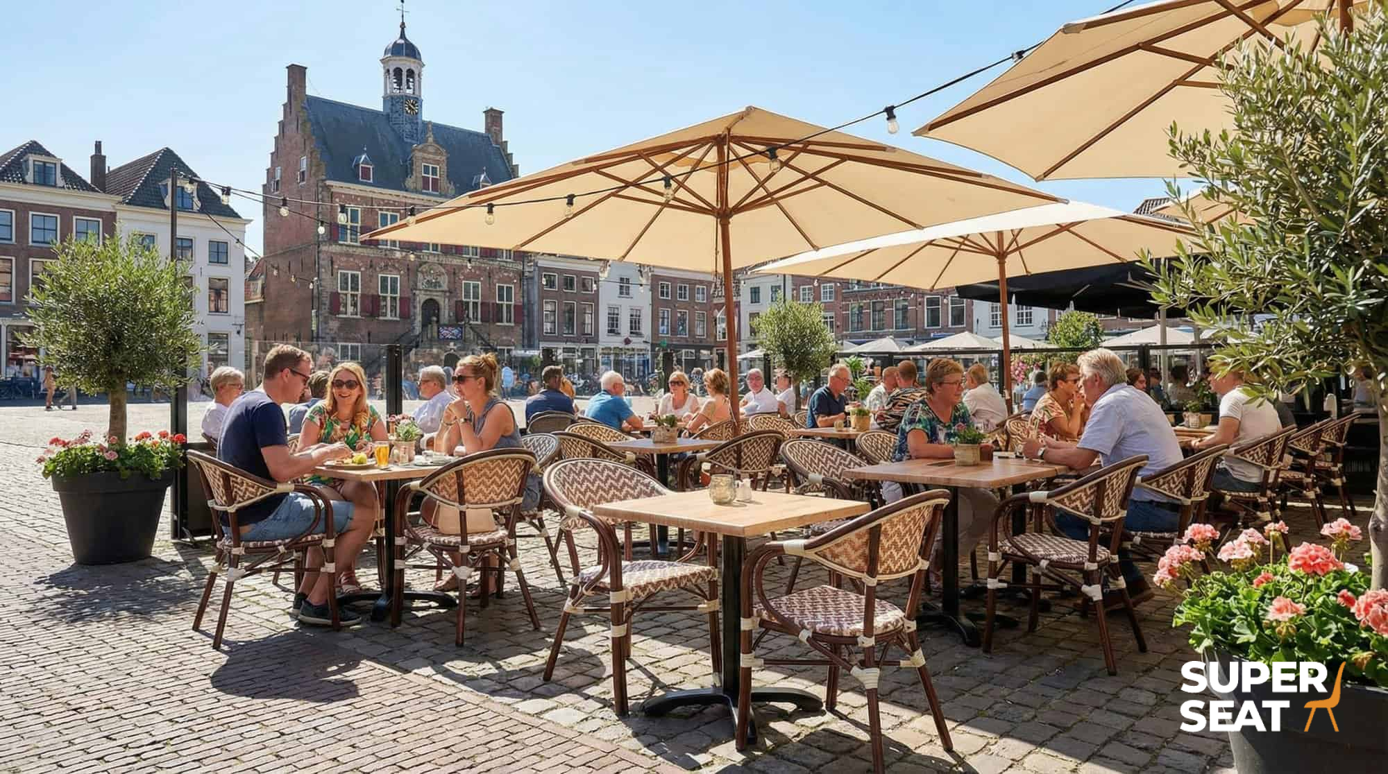 Super-Seat | Marylin Parisian hospitality terrace | Boho beige chairs, arm chairs and wood/metal tables on cobblestone square with umbrellas. | Hospitality Furniture