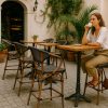 Super-Seat | Textile hospitality (patio) bark stools curved brown | Brown, curved textile bark stools with metal frame between green and patio pots. | Hospitality Furniture