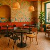 Super-Seat | A cozy café with floral wallpaper | Rode stoffen bank, houten en zwarte melamine stoelen, zwarte ronde melamine tafels |. | Horecameubilair