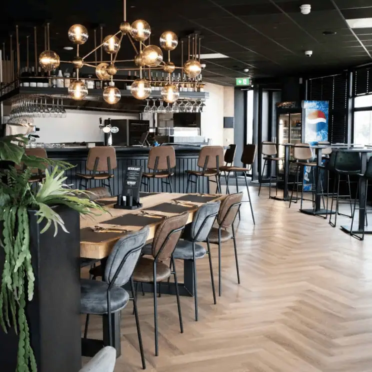 Super-Seat | Modern restaurant design | Super chairs on herringbone wood floor, stylish chandelier, visible bar with Pepsi refrigerator |. | Hospitality Furniture