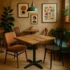 Super-Seat | A cozy cafe with a Hospitality tables mango wood “World” series table of 70x70cm and two non-matching chairs | Mango wood table, a green fabric sofa, metal and wooden chairs, warm beige tones. | Hospitality Furniture