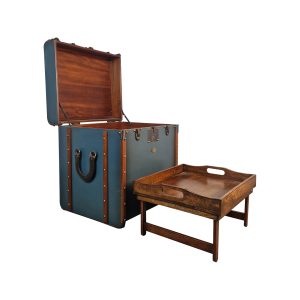 Super-Seat | Blue suitcase side table with brown leather straps, metal details, next to a white tray table. | Hospitality Furniture