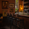 Super-Seat | A cozy bar with Jody catering bar stools Four black/brown stackable bar stools made of metal, wooden bar, brown walls, plants. | Hospitality Furniture