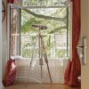 Super-Seat | Two white metal chairs on balcony, looking at green trees, red curtain. | Hospitality Furniture