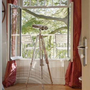 Super-Seat | Two white metal chairs on balcony, looking at green trees, red curtain. | Hospitality Furniture