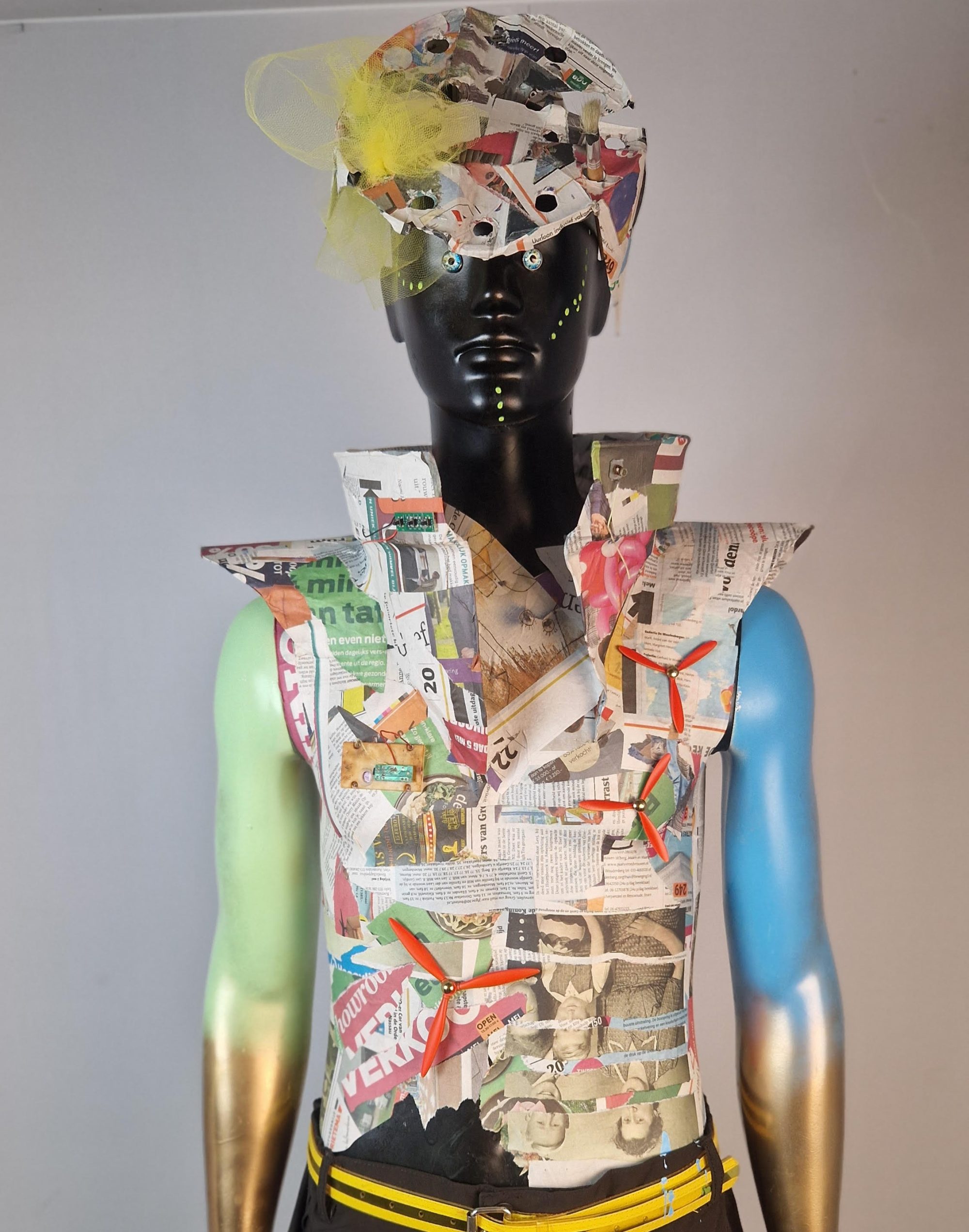 Super-Seat | Mannequin with garish outfit of newspaper, tulle & decorative stones; arms painted blue-gold. | Hospitality Furniture